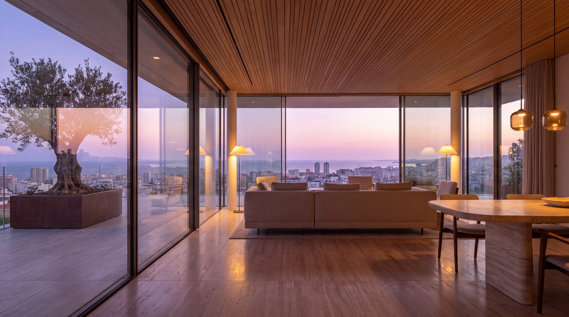 Render interior del salón de un ático al anochecer abierto a una terraza con el skyline de Barcelona y el mar