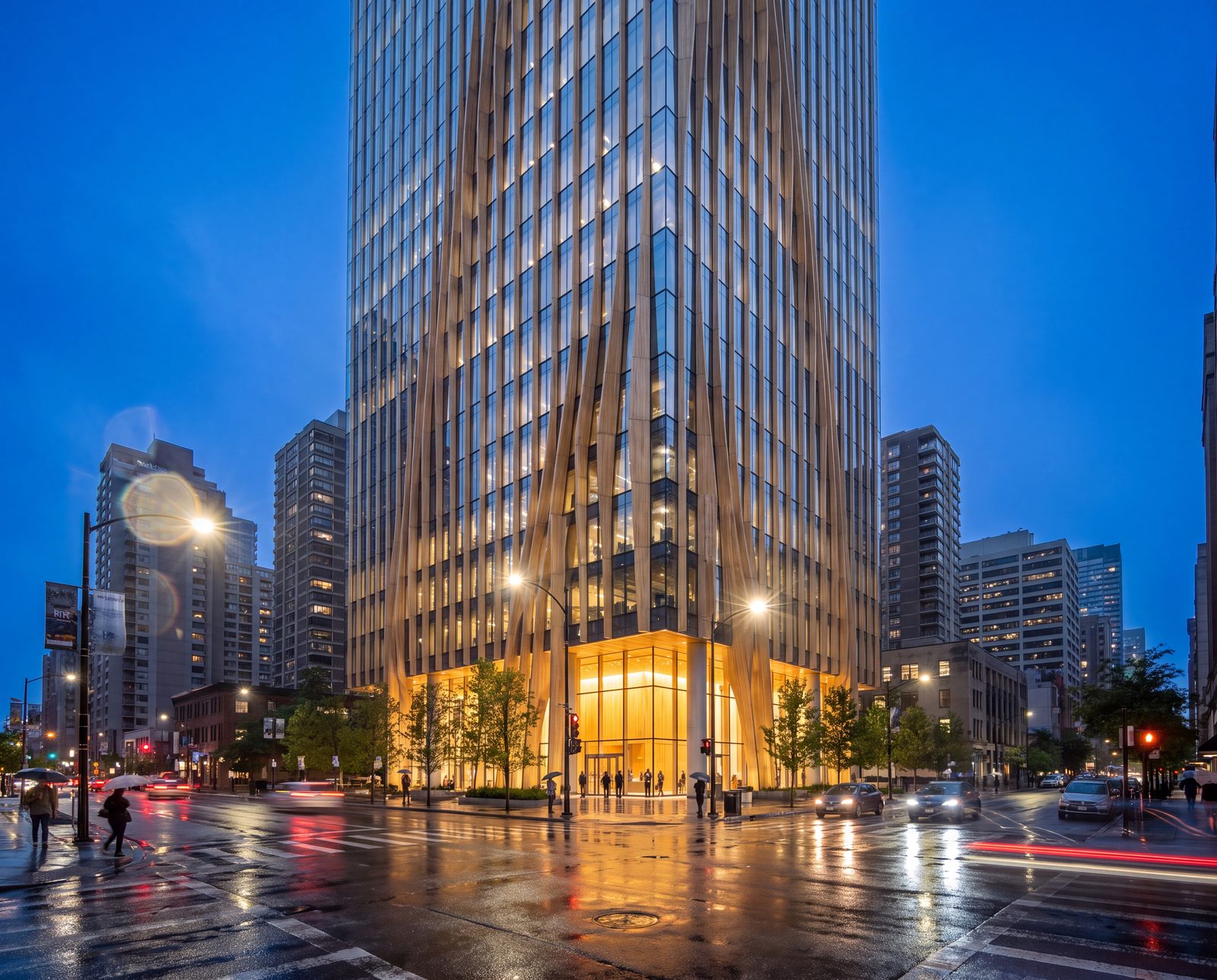 A glass curtain wall shaded by twisting timber fins, seen from the street just after rain